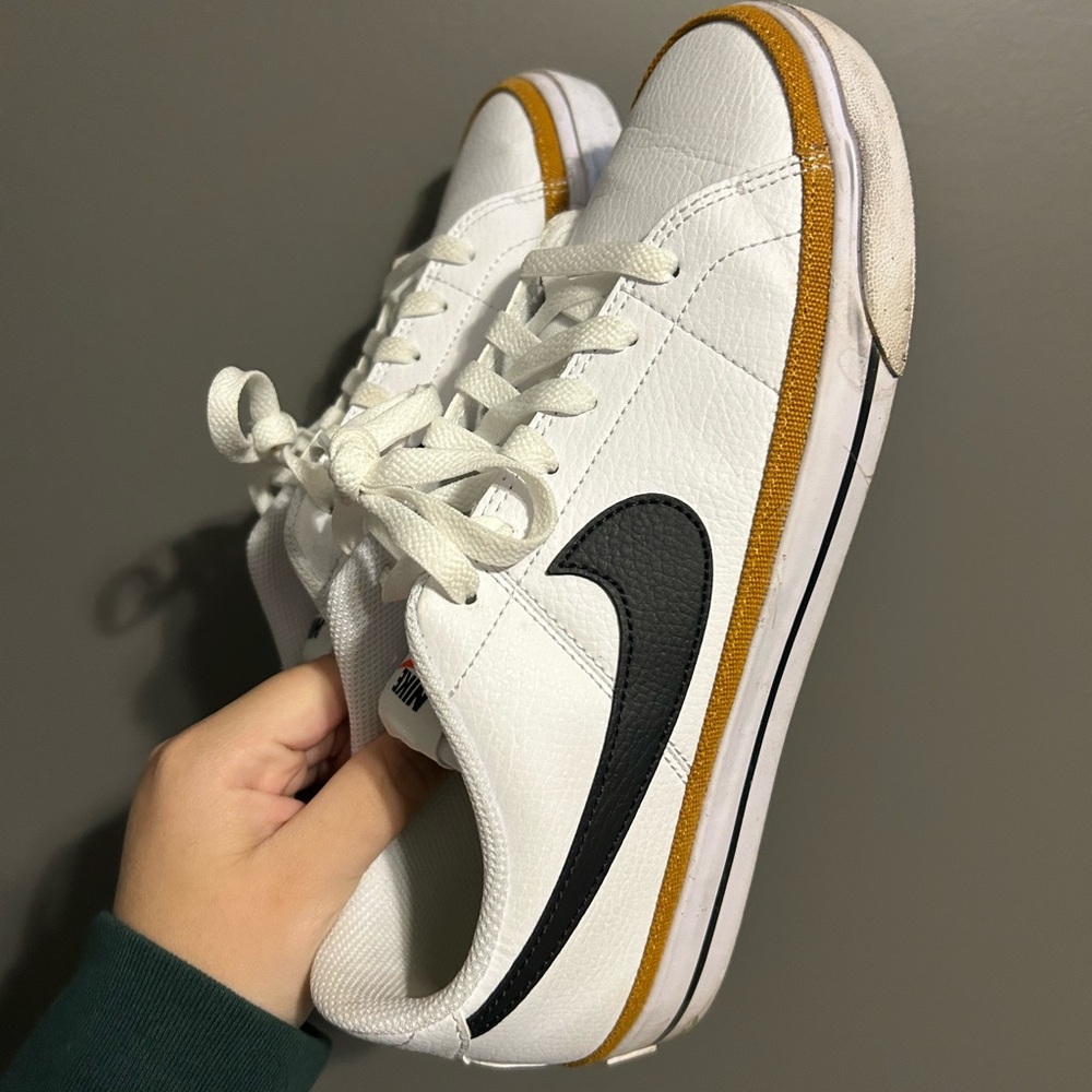 Nike White Sneakers with Black Swoosh and Gold Trim